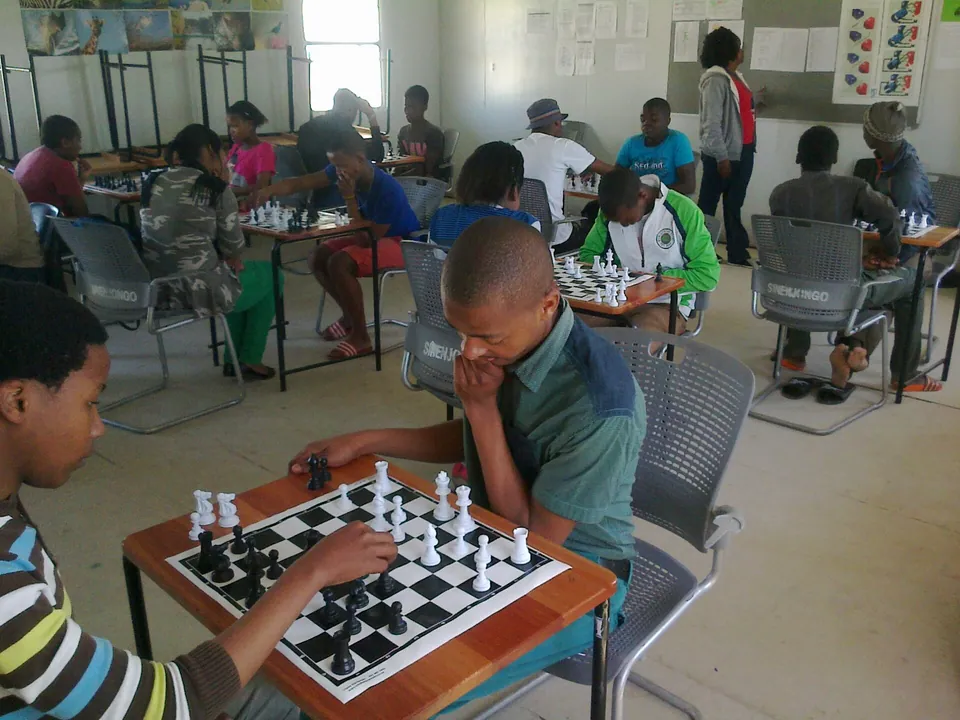A boy concentrating on his chess game
